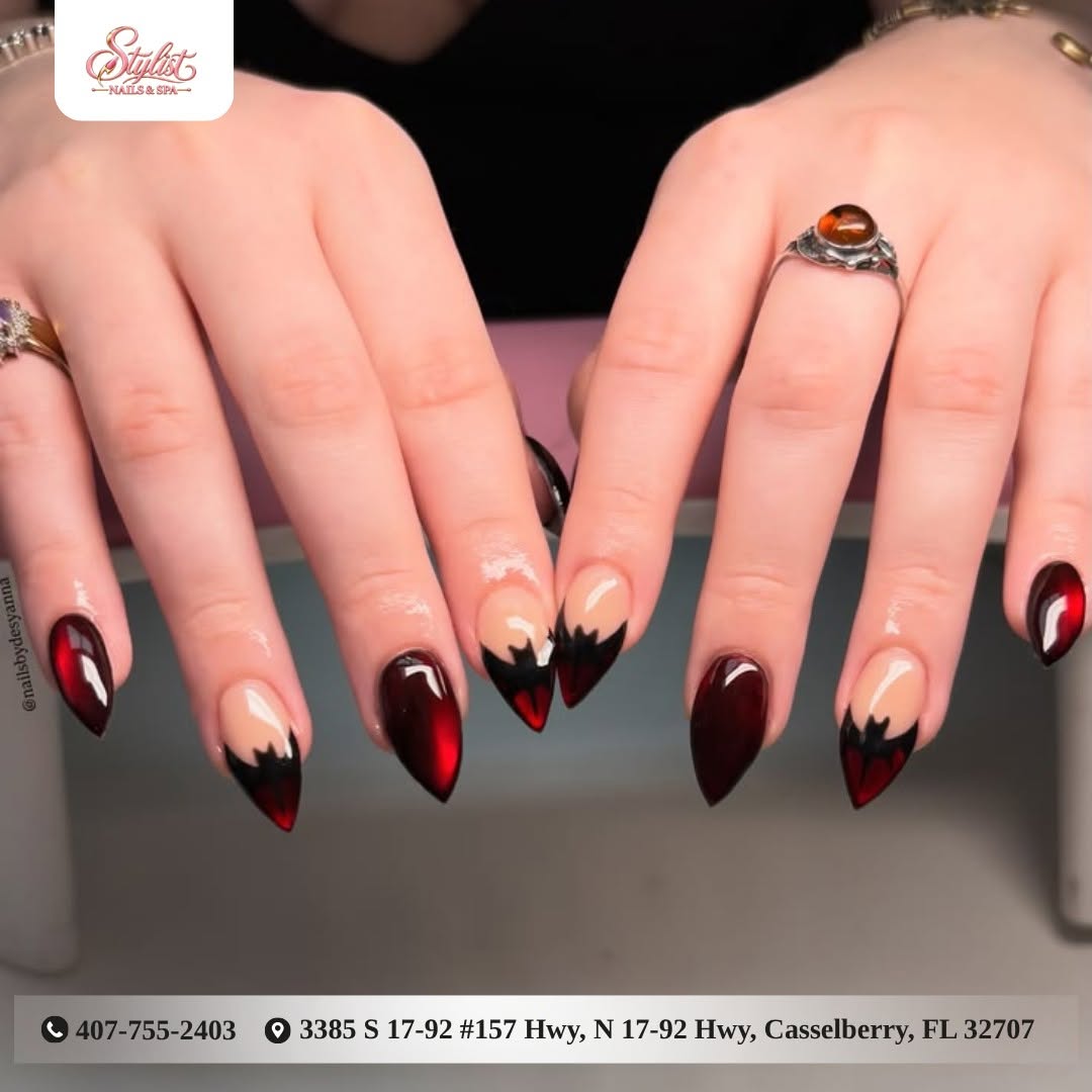 Deep red almond nails with a black tip design