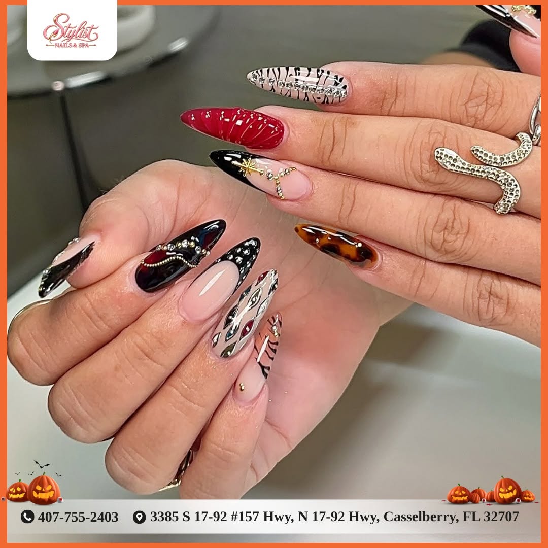 Custom mixed nail art with gems, tortoiseshell, and red chrome
