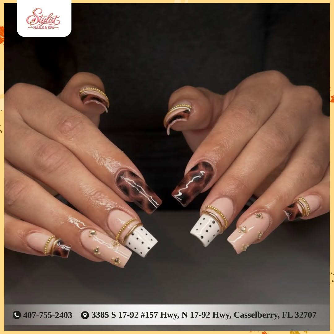 Square nails with tortoiseshell, gold rings, and rhinestones