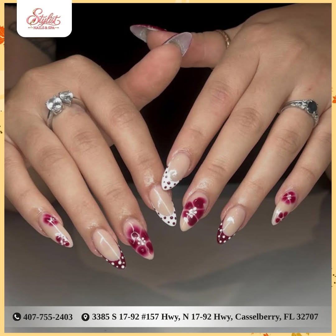 Burgundy floral almond nails with a dotted French tip