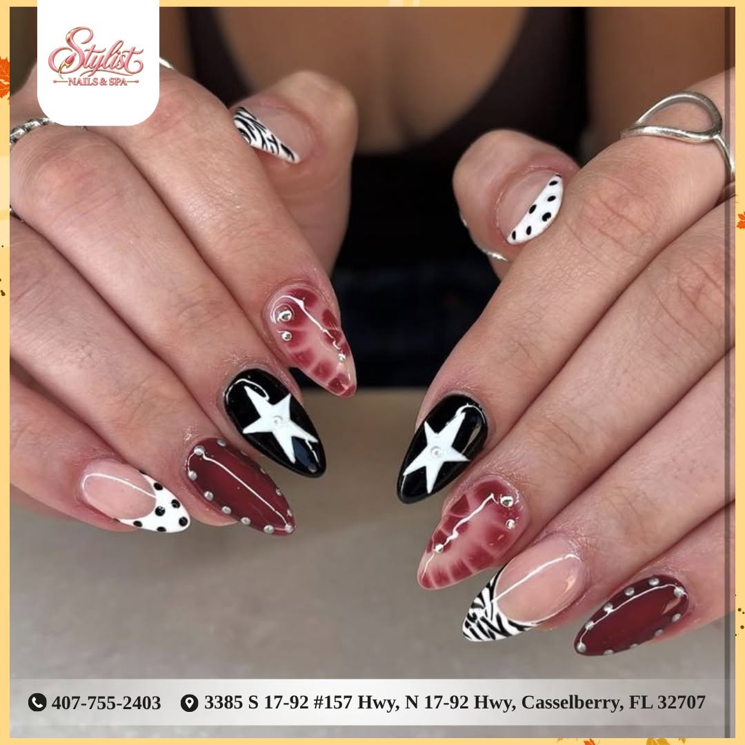 Black-and-white star nails with zebra and burgundy details